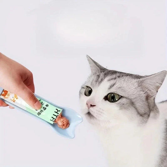 Cat Strip Feeder Spoon dispensing wet treat to a cat