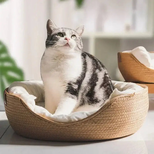 Cozy Nest Cat Bed with bamboo weave pattern on wooden floor
