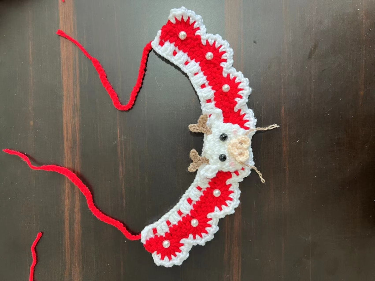 Christmas pet collar with green lace and red tulip pattern worn by a fluffy cat